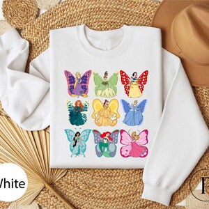 a white shirt with a picture of a group of butterflies on it