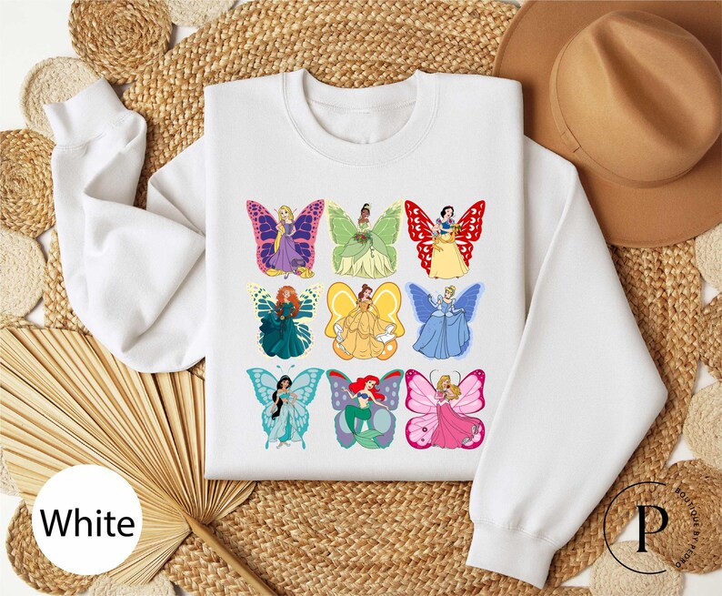 a white shirt with a picture of a group of butterflies on it