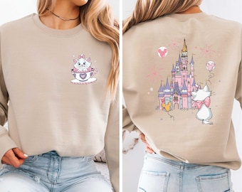 May include: A beige sweatshirt with a cartoon cat in a teacup on the front and a cartoon castle with a cat on the back.