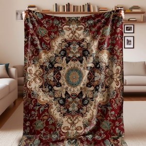 May include: A large, ornate blanket with a Persian rug design. The blanket features a deep red background with a central medallion in cream, teal, and gold. Intricate floral and scroll patterns cover the surface.