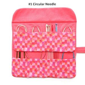 May include: A pink fabric roll-up case with a checkered pattern and a label that says "#1 Circular Needle". The case is open and contains a variety of circular knitting needles.