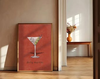 May include: A framed print of a martini glass with olives and ice on a red background. The text "dirty martini" is printed below the glass.