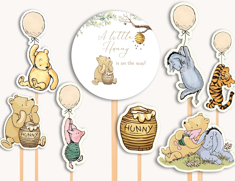 May include: Winnie the Pooh themed baby shower cake toppers. The set includes a round cake topper with the text "A little Hunny is on the way!" and several character toppers including Winnie the Pooh, Piglet, Eeyore, Tigger, and a honey pot.