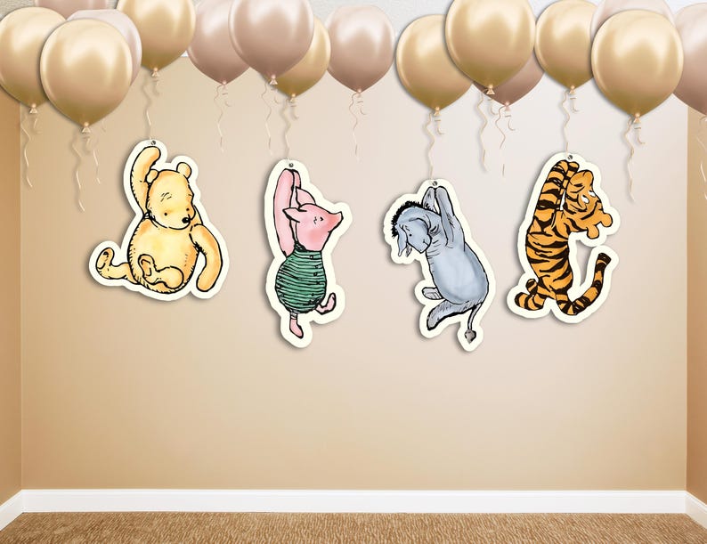 May include: Four Winnie the Pooh character cutouts hanging from gold balloons. The characters are Winnie the Pooh, Piglet, Eeyore, and Tigger.