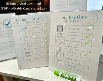 May include: Two white framed routine charts, one for morning and one for bedtime. The morning chart includes a sun graphic and the text "my morning ROUTINE". The bedtime chart includes a moon graphic and the text "my bedtime ROUTINE". A green dry-erase marker is in the foreground.