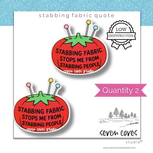May include: Two red tomato-shaped pincushion stickers with green tops and three pins with colorful heads. The text reads: STABBING FABRIC STOPS ME FROM STABBING PEOPLE. The stickers are labeled with the text Seven Coves Studio and Quantity 2.