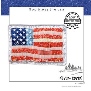 May include: A patriotic American flag design with a blue star field and red and white stripes. The flag is framed with a silver border and the text "God bless the usa" is above the flag.