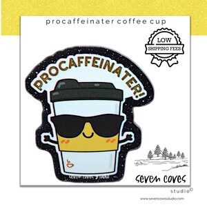 May include: A sticker featuring a cartoon coffee cup wearing sunglasses with the text "procaffeinater!" in gold lettering. The sticker has a black glitter border and the words "seven coves studio" are at the bottom.