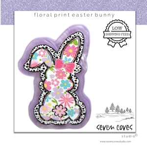 May include: A floral print Easter bunny design. The bunny is filled with colorful flowers and a pink bow. The design is outlined in black polka dots and set against a lavender background. The image includes the text "floral print easter bunny" and "low shipping fees".