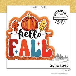May include: A decorative cutout with an orange glitter border featuring a central orange pumpkin flanked by two autumn leaves. The text reads hello in black script and FALL in large, colorful block letters with small star accents.
