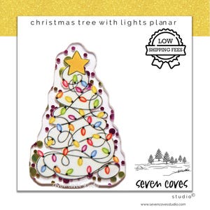 May include: A white Christmas tree with a yellow star on top and colorful lights wrapped around it. The tree is on a purple background with gold glitter. The text "Seven Coves Studio" is at the bottom of the image.