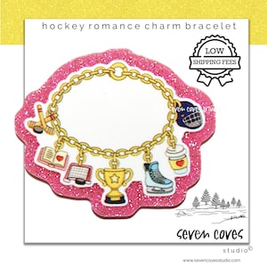 May include: A pink glittery charm bracelet with gold chain and hockey-themed charms. Charms include a hockey stick and puck, a book, a hockey net, a trophy, a skate, and a coffee cup. The text "hockey romance charm bracelet" is at the top.