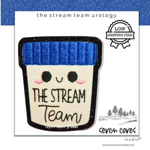 May include: A white patch with a blue rim and a blue textured top, featuring a smiling face and the words "THE STREAM Team". The patch also includes the text "the stream team urology" and "seven coves studio".