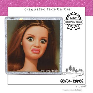 May include: A square coaster featuring a doll with long brown hair and a disgusted facial expression. The text "disgusted face barbie" is printed at the top, and "seven coves studio" is at the bottom. A badge reads "LOW SHIPPING FEES".