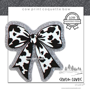 May include: A cow print coquette bow with a glittery silver border. The bow features a black and white spotted pattern. The text "cow print coquette bow" is at the top. The logo for "seven coves studio" is at the bottom.