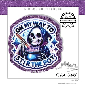 May include: A purple glitter flat back featuring a cartoon Grim Reaper stirring a cauldron. The text reads "On My Way To Stir The Pot". The design includes stars and a blue and purple color scheme.