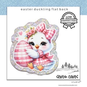 May include: A cute Easter duckling flat back design. The duckling wears a pink gingham bow and dress, holding a pink and white patterned Easter egg. The design includes the text "Easter duckling flat back".