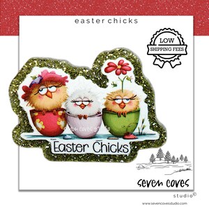 May include: An illustration of three cartoon chicks in colorful eggshell cups. The chicks have expressive eyes and are adorned with accessories. The text "Easter Chicks" is displayed below the chicks, with the words "low shipping fees" in a badge.