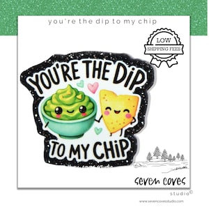 May include: A white sticker with the text "You're the dip to my chip" featuring a cartoon avocado in a bowl and a tortilla chip. The sticker has a black glitter border and the words "seven coves studio" at the bottom.