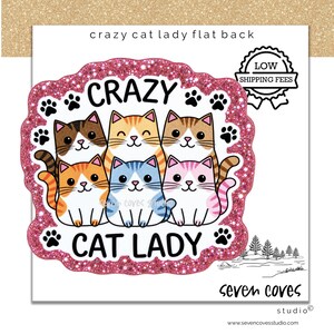 May include: A flat back decorative piece featuring six cartoon cats in various colors including brown, orange, blue, and pink. The text CRAZY CAT LADY is printed in black, surrounded by a pink glitter border and small black paw prints.