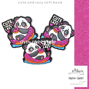 May include: Three panda bear soft beads, each with a pink donut and the text "CUTE -AN-D- LAZY". The pandas are black, white, and gray, with the donuts having pink frosting and colorful sprinkles. The text "cute and lazy soft bead" is at the top.
