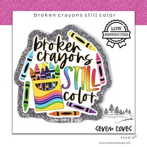 May include: A sticker with the text "broken crayons still color" in a colorful design. The sticker features a box of crayons, individual crayons, and a glittery border. The words "LOW SHIPPING FEES" are also present.