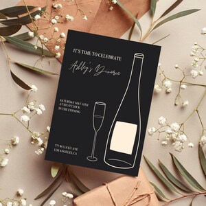 May include: Black and white invitation card with the text "It's time to celebrate Ashley's Divorce" and a line drawing of a champagne bottle and glass. The text "Saturday May 18th at six o'clock in the evening" and "777 W Lucky Ave Los Angeles, CA" are also included.