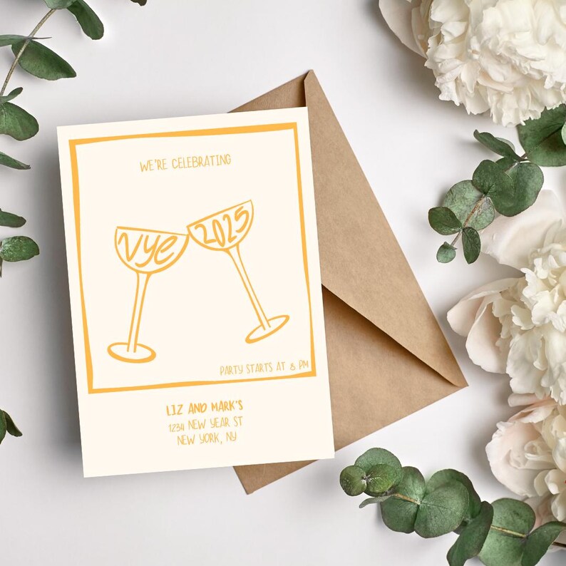 May include: A white card with a gold border and a gold illustration of two champagne glasses clinking. The text "WE'RE CELEBRATING" is at the top of the card. The glasses have the text "Vye" and "2025" written on them. The text "PARTY STARTS AT 8 PM" is below the glasses. The text "LIZ AND MARK'S" is at the bottom of the card, followed by an address.