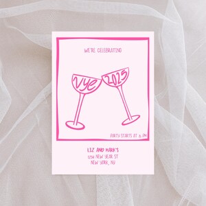 May include: Pink and white New Year's Eve party invitation with a graphic of two champagne glasses clinking. The text reads "We're celebrating" and "Vye 2025". The party starts at 8 PM. The invitation is for Liz and Mark's at 1234 New Year St, New York, NY.