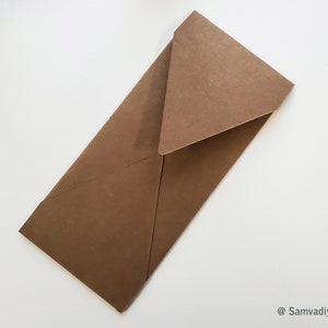 May include: A brown paper envelope with a triangular flap. The envelope is folded and ready to be sealed.