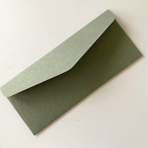 May include: A light green envelope with a textured surface.