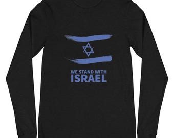 May include: Black long-sleeved top with a blue Star of David and two blue brushstrokes, resembling a flag. The text "WE STAND WITH ISRAEL" is below the graphic. The shirt is made of a soft material.