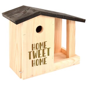 May include: A wooden birdhouse with a dark brown roof and the words "HOME TWEET HOME" etched on the front. The birdhouse has a circular entrance hole and an open feeding area. The wood has a natural, light color.