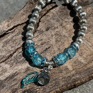 Beaded,  light blue and irridesent bracelet. Child size