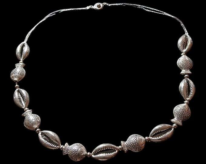 Cowrie shell and fish stainless steel choker.