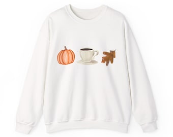 May include: White sweatshirt featuring a watercolor design of a pumpkin, a coffee cup, and a leaf. The pumpkin is orange, the coffee cup is white with a black coffee, and the leaf is brown. The sweatshirt has a crew neck and long sleeves.