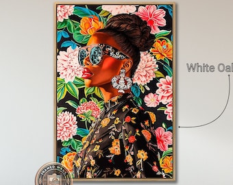May include: A framed print of a woman with dark skin wearing sunglasses and a floral dress. The background is a colourful floral pattern. The frame is white oak.