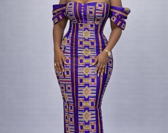 May include: A floor-length, off-the-shoulder dress with a vibrant geometric pattern in shades of purple, yellow, and brown. The dress features a fitted bodice and a straight skirt. The sleeves are short and slightly puffed. The dress is a striking example of African-inspired fashion.