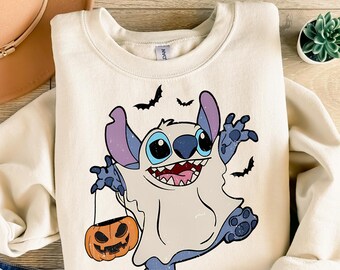 May include: Cream-colored sweatshirt featuring a Halloween-themed graphic. The design includes a cartoon character in a ghost costume, holding a jack-o'-lantern. The text "Ready to press DTF Transfer" is at the top. Black bats are also included in the design.