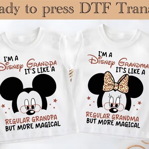 May include: Two white t-shirts with the text "I'M A Disney Grandpa" and "I'M A Disney Grandma" with Mickey and Minnie Mouse graphics. The shirts also read "It's Like A Regular Grandpa/Grandma But More Magical". The words "Ready to press DTF Transfer" are at the top.