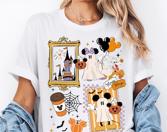 May include: White t-shirt featuring a Halloween-themed graphic with cartoon characters, pumpkins, and a castle. The design includes the text "Magic" and "Ready to press DTF Transfer". The artwork is in shades of orange, purple, black, and yellow.