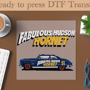May include: A blue and yellow illustration of a vintage car with the text "FABULOUS HUDSON HORNET" on the side. The car is on a light brown background.