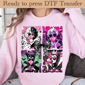 May include: Pink sweatshirt featuring a graphic of four cartoon characters blowing bubblegum bubbles. The characters are in a square grid, with a black bow in the center. The text "Ready to press DTF Transfer" is at the top.