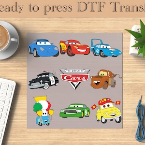 May include: A set of eight iron-on transfers featuring characters from the Disney Pixar movie Cars. The transfers include Lightning McQueen, Mater, and other characters. The transfers are ready to be pressed onto fabric.