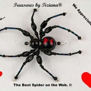 May include: Black beaded spider with red hourglass markings on its abdomen. The spider is surrounded by red hearts and the text "Thank You... Treasures by TizianaⓇ We Appreciate Your Support... The Best Spider on the Web.Ⓡ"