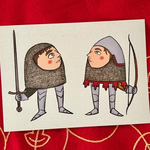 May include: A rectangular print featuring two stylized figures in medieval armor. The left figure wears a chainmail coif and holds a long sword. The right figure wears a helmet and holds a bow. Both have round faces and visible leg armor.