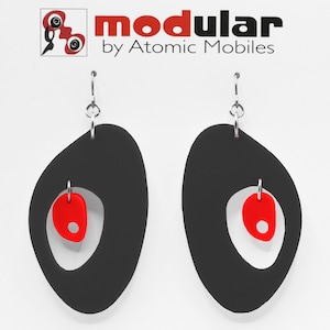 May include: A pair of black and red dangle earrings with a unique geometric design. The earrings are made of polymer clay and feature a silver hook.