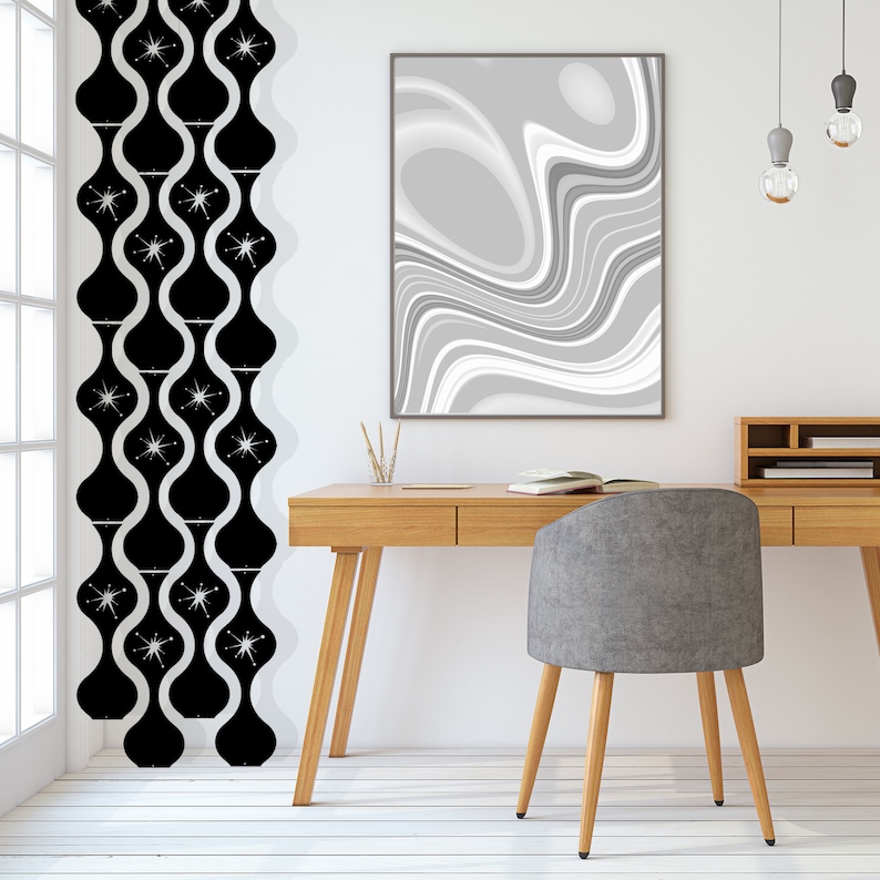 May include: A mid-century modern interior with a wooden desk, gray chair, and abstract art. Black and white patterned curtains hang near a window. Decorative pendant lights hang above the desk.