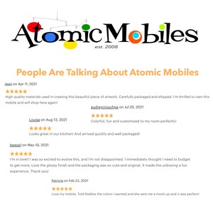 May include: The Atomic Mobiles logo with the text "est. 2008" is displayed at the top of the image. Below, the text "People Are Talking About Atomic Mobiles" is shown, followed by customer reviews with star ratings and comments about the products.