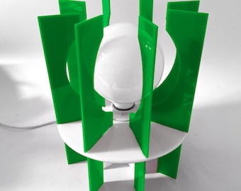 May include: A white table lamp with a green geometric shade. The shade is made of multiple panels that create a unique and modern design.